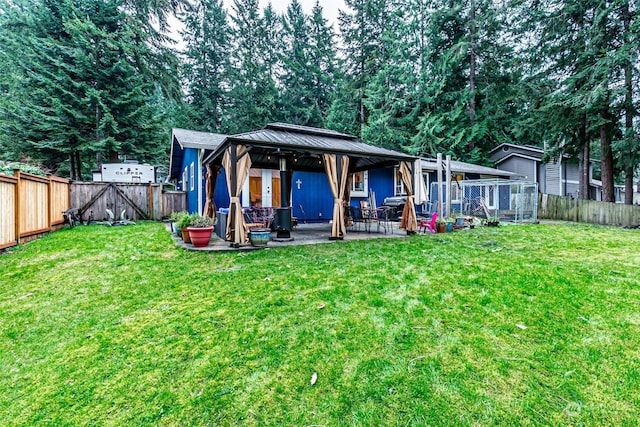 back of house featuring a yard and a patio