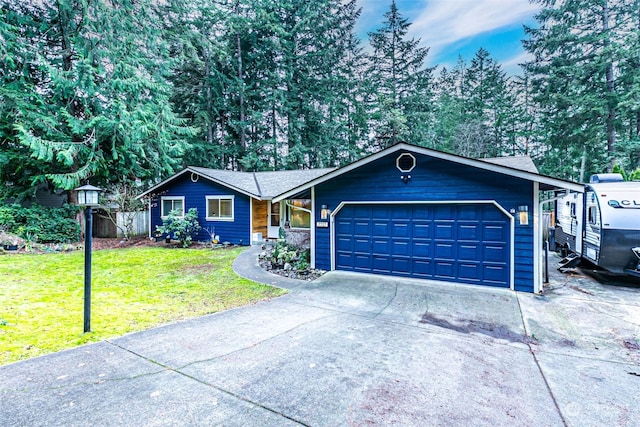 ranch-style home featuring a front lawn and a garage