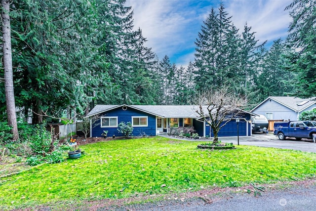 ranch-style home with a front yard and a garage