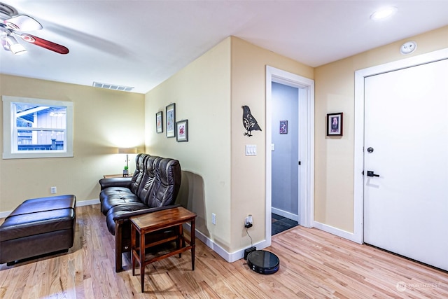 sitting room featuring ceiling fan and light hardwood / wood-style floors