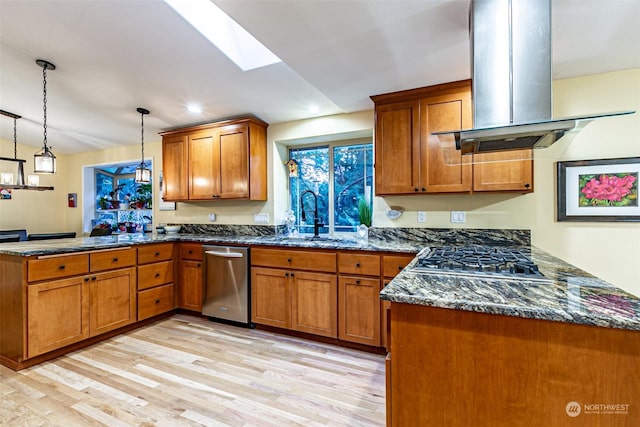 kitchen featuring island range hood, stainless steel appliances, light wood-type flooring, kitchen peninsula, and decorative light fixtures