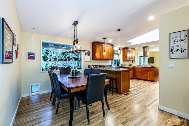 dining space featuring light hardwood / wood-style floors and sink