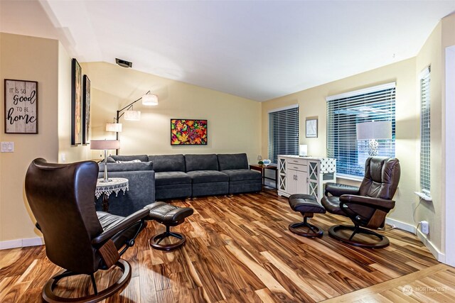 living room with lofted ceiling and light hardwood / wood-style floors