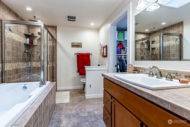 full bathroom with toilet, separate shower and tub, and vanity