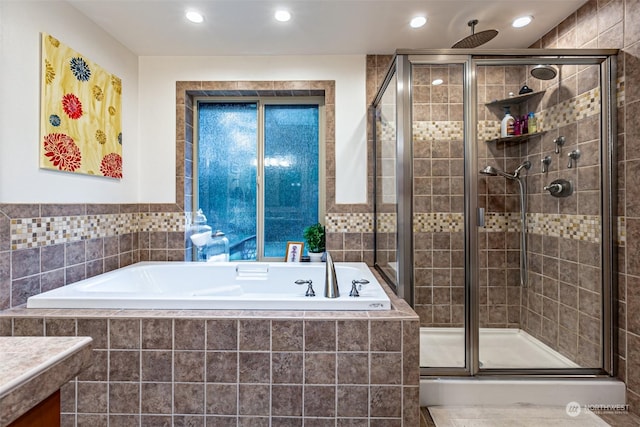 bathroom with shower with separate bathtub