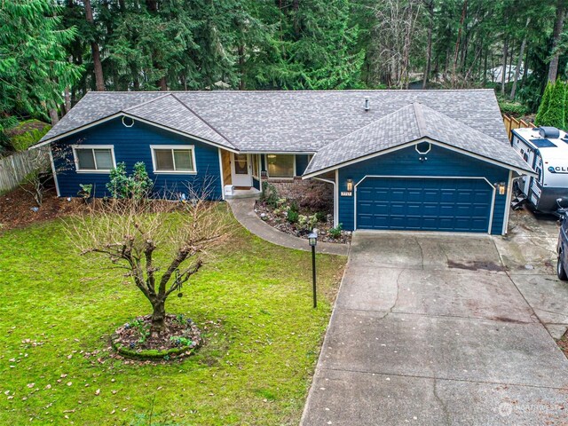 ranch-style home featuring a front lawn and a garage