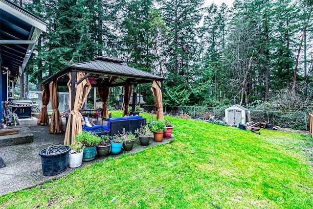 view of yard with an outdoor hangout area, a storage unit, and a gazebo