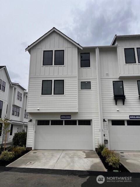 view of front facade featuring an attached garage, board and batten siding, and driveway