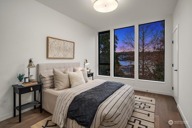 bedroom with dark hardwood / wood-style flooring