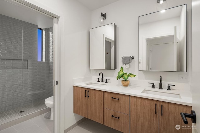 bathroom featuring tile patterned flooring, vanity, toilet, and an enclosed shower