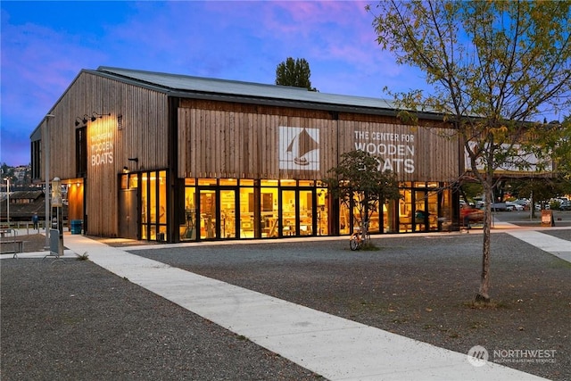 view of outdoor building at dusk