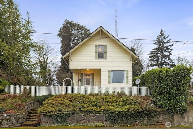 bungalow-style home with fence