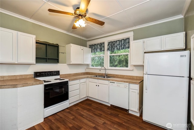 kitchen with white appliances, white cabinets, dark wood-style flooring, crown molding, and a sink