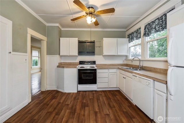 kitchen with white appliances, a sink, dark wood finished floors, and white cabinets