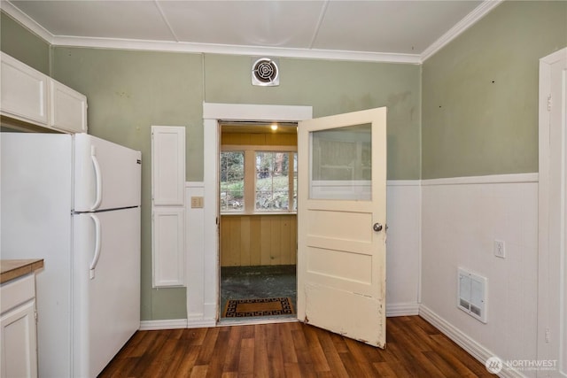 kitchen with freestanding refrigerator, dark wood-style flooring, white cabinets, and visible vents