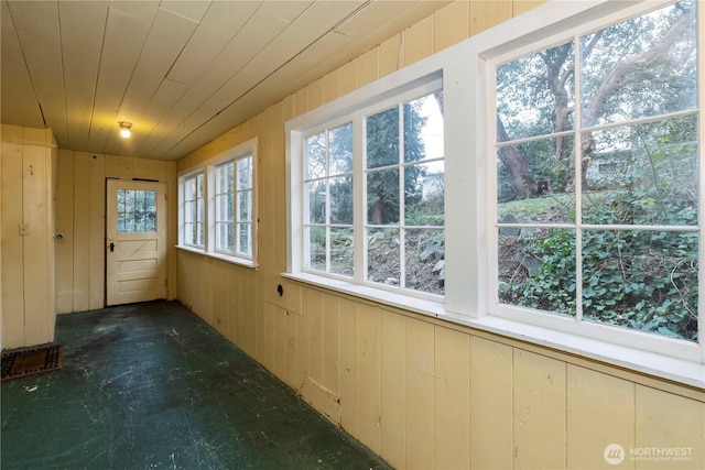 unfurnished sunroom with wooden ceiling