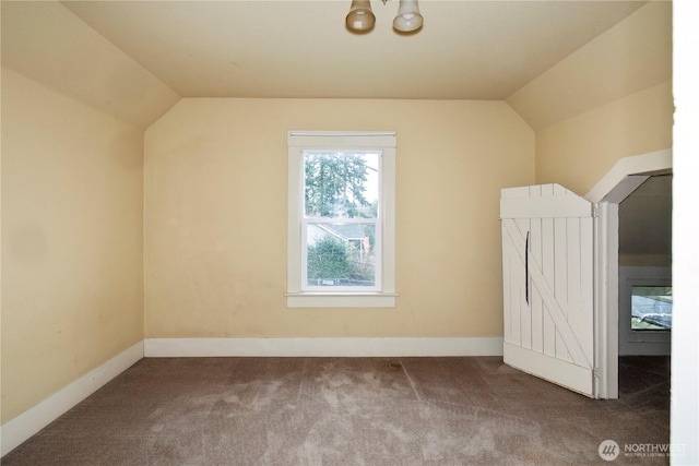 bonus room featuring lofted ceiling, baseboards, and carpet flooring