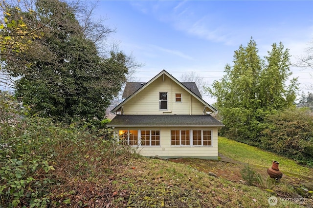 rear view of property with a yard