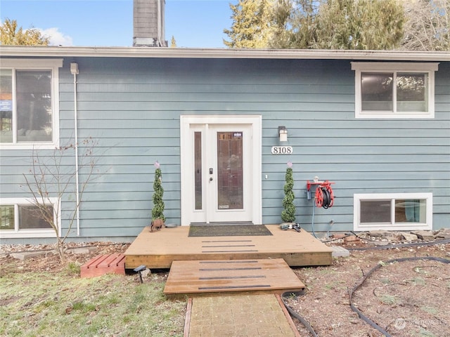 view of exterior entry with a deck