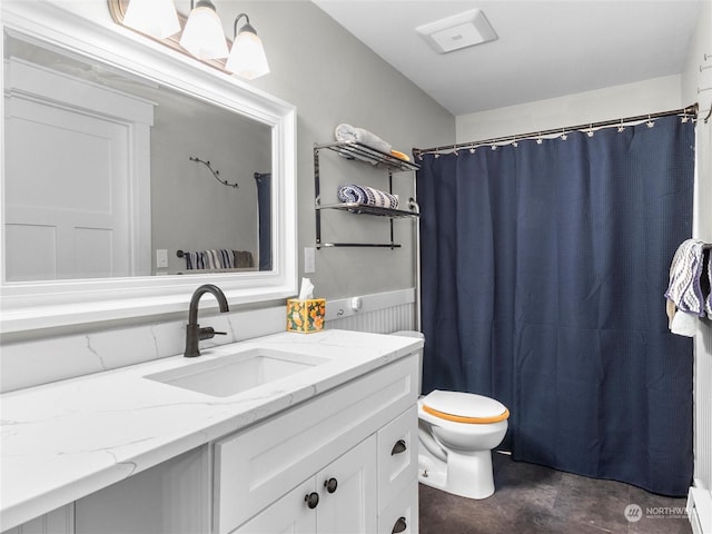 bathroom with concrete flooring, toilet, baseboard heating, vanity, and curtained shower