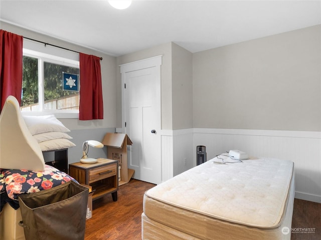 bedroom with dark wood-type flooring