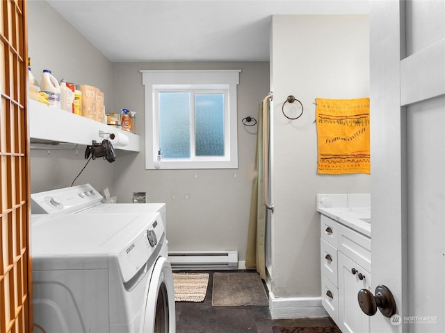 clothes washing area with a baseboard radiator and separate washer and dryer