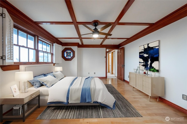 bedroom with beam ceiling, light hardwood / wood-style flooring, and coffered ceiling