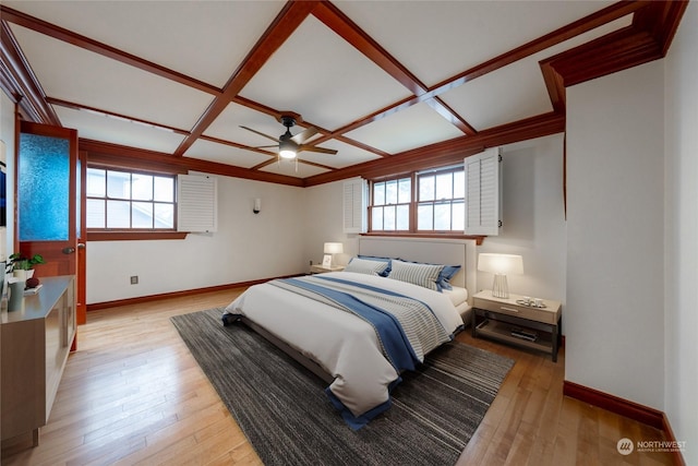 bedroom with coffered ceiling, multiple windows, ceiling fan, and light wood-type flooring