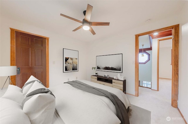 bedroom featuring ceiling fan and light colored carpet