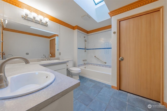 full bathroom featuring tiled shower / bath, toilet, a skylight, vanity, and crown molding