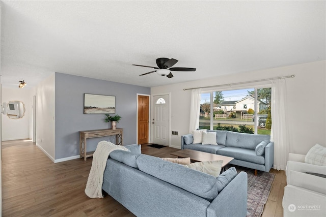 living room featuring ceiling fan and hardwood / wood-style flooring