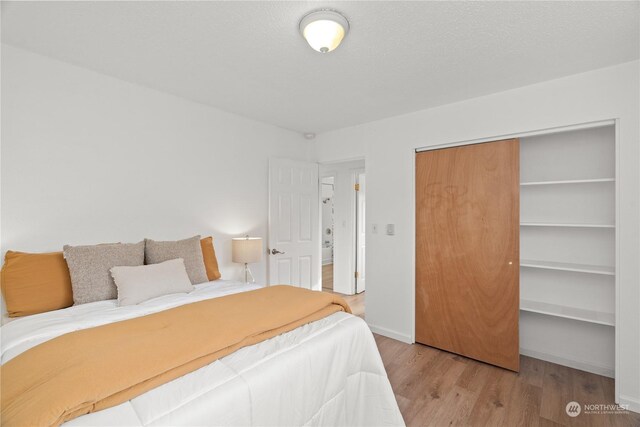 bedroom featuring light wood-type flooring and a closet