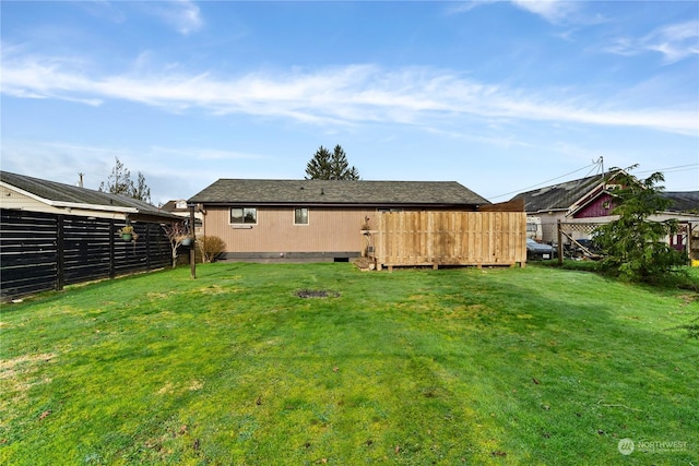 back of house featuring a lawn