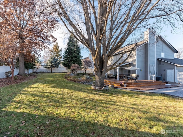 view of yard featuring a wooden deck and central AC unit