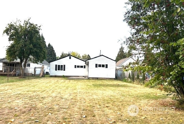 back of house with a lawn