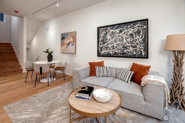 living room featuring hardwood / wood-style flooring and track lighting