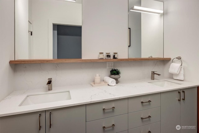 bathroom featuring tasteful backsplash and vanity