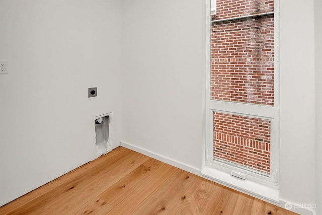 clothes washing area with electric dryer hookup and hardwood / wood-style floors