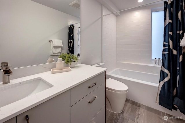 full bathroom featuring toilet, vanity, and shower / bath combination with curtain