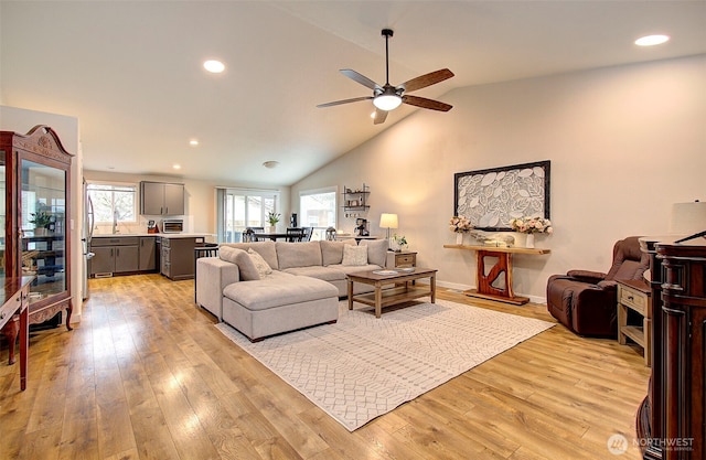 living area featuring a ceiling fan, recessed lighting, light wood finished floors, and a wealth of natural light