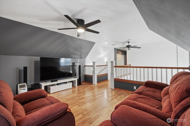 living room featuring ceiling fan, light wood-type flooring, and vaulted ceiling