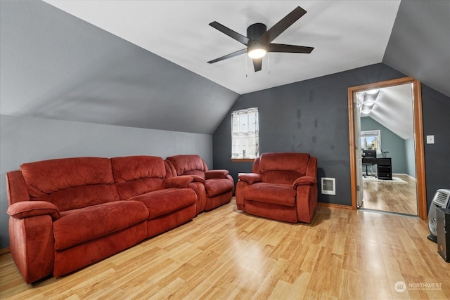 living room with ceiling fan, vaulted ceiling, and light hardwood / wood-style flooring