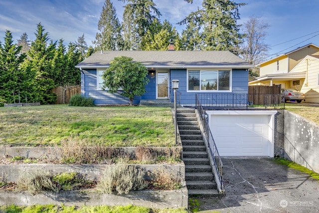 view of front facade with a front yard and a garage