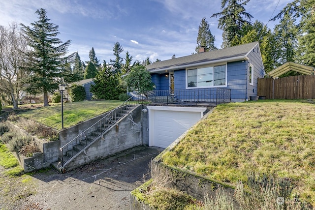 ranch-style home with a front yard and a garage