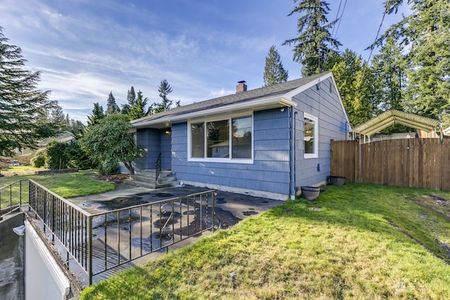 exterior space featuring a front lawn and a patio