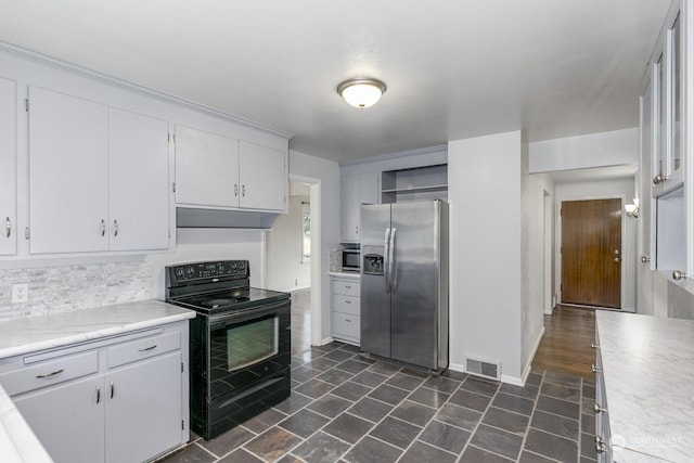 kitchen featuring backsplash, white cabinets, and stainless steel appliances