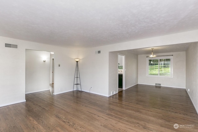 unfurnished room with dark hardwood / wood-style flooring