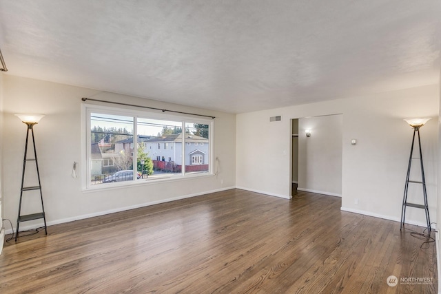 empty room with dark wood-type flooring