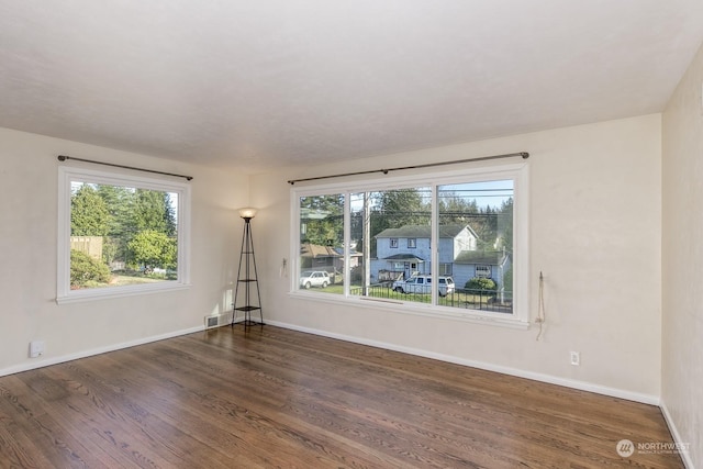 empty room featuring dark wood-type flooring