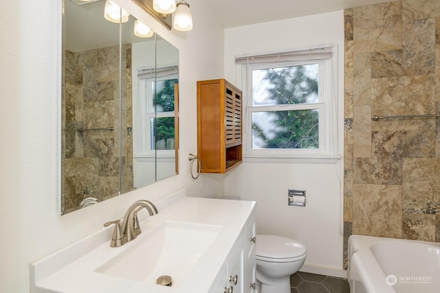 full bathroom with tile patterned flooring, vanity, toilet, and tiled shower / bath